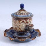 A late 19th century Doulton Lambeth stoneware isobath inkwell, relief decorated with stylised