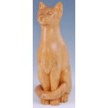 A large contemporary carved sycamore model of a seated cat, tail curled around front paws, incised