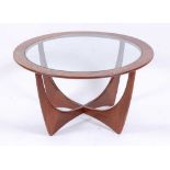 A 1960s G-Plan teak circular 'Astro' coffee table, having a smoky glass inset top, h.46cm, dia.84cm