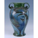 A large 1905 Charles Brannam Burem ware vase, of baluster form, flanked by twin scrolled handles,