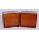 A pair of 1970s G-Plan teak low double door side cupboards, each with sliding doors and single