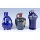 An early 20th century Royal Doulton Lambeth stoneware carafe, relief decorated with stylised