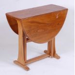 A 1960s Ercol light elm dropflap breakfast table, having opposing gateleg action, h.72cm, max length