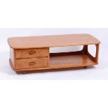 An Ercol light elm 'Pandora's Box' long coffee table, having twin short drawers, open compartment,
