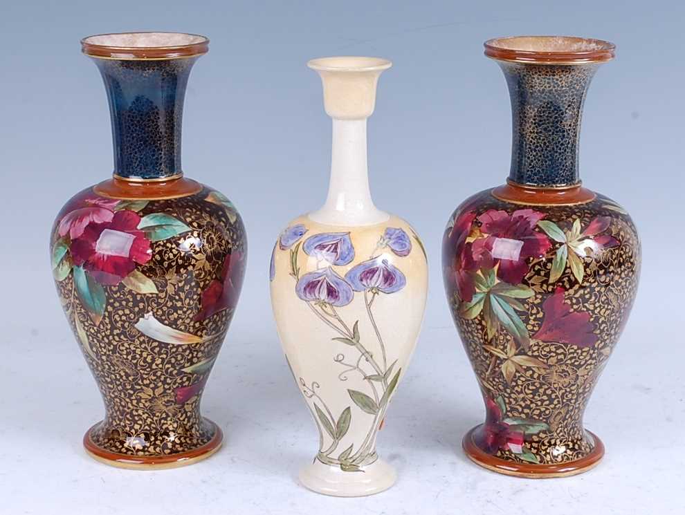 A near pair of early 20th century Royal Doulton Lambeth vases, of baluster form, with floral