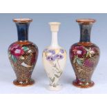 A near pair of early 20th century Royal Doulton Lambeth vases, of baluster form, with floral