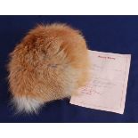 Shirley Bassey, a red fox fur hat, bearing a label for Simone Mirman and hand written "Shirley