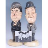 A pair of late 20th century American glazed and painted models of Stan Laurel and Oliver Hardy, each