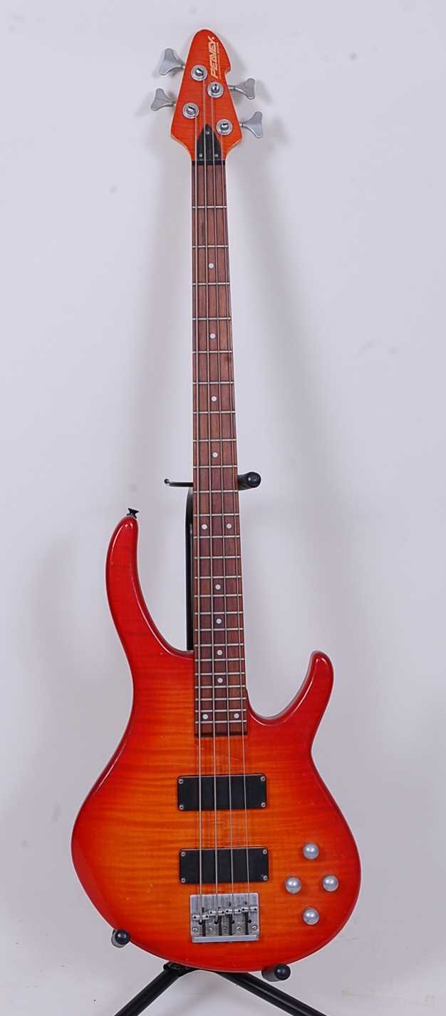 A Peavey International Series four string bass guitar, orange finish.