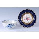 An 18th century Worcester porcelain slop bowl, blue and white decorated with fruit, crescent mark