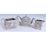 A mid Victorian silver three-piece tea service, each piece of repousse floral and scrolling