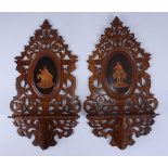 A pair of circa 1900 continental olivewood, marquetry and penwork decorated wall brackets, each
