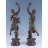 After Henryk Kossowski (1855-1921) - a pair of bronzed spelter figurines of maidens, each with a