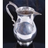 A George VI silver sparrowbeak cream jug, of plain bellied form with S scroll handle and on reeded