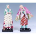 A pair of late 19th century German porcelain figures, each shown in 18th century dress with enamel