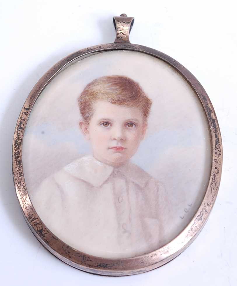 An early 20th century double-sided miniature locket in silver frame, watercolour on ivory head and