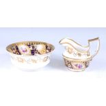 An early 19th century Spode porcelain milk jug and slop bowl, each decorated with floral