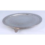 A late Victorian silver tray, having engraved banded decoration and raised on scroll feet, 25.8oz,