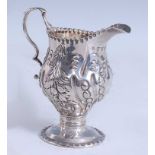 A George III silver miniature cream jug, of baluster form to a pedestal and spreading circular foot,