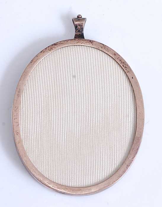 An early 20th century double-sided miniature locket in silver frame, watercolour on ivory head and - Image 2 of 5