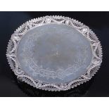 A Victorian silver circular salver, having raised pierced and repousee crested border decorated with