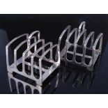 A pair of Edwardian silver four division toast-racks, on H shaped base and with curved loop handles,