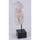 A large Roman style carved and variegated white marble torso of Venus, after the antique, the