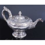 A George III silver teapot, of inverted baluster form upon a spreading reeded foot, the body