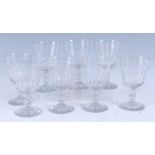 A set of eight early Victorian pedestal wine glasses, each having thumbcut conical bowls and on