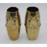 A pair of early 20th century brass vases, each repoussee decorated with stylised flowers, height