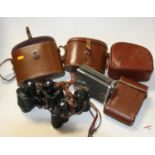 Two pairs of leather cased binoculars, together with a Bell & Howell 16mm magazine camera, and an