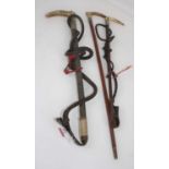 A collection of three various antler handled leather riding crops