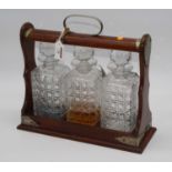 A 20th century oak cased three bottle tantalus, width 33cm