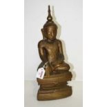 A carved and gilt painted wooden figure of a buddha seated, height 42cm