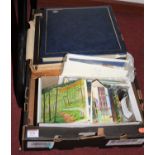 A box of various albums of photographs and tea and cigarette cards