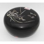 A 20th century Japanese black lacquered and mother-of-pearl inlaid circular box and cover, dia. 19cm