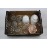 A collection of glass, copper, and pottery jelly moulds