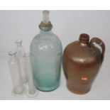 A lustre glazed stoneware flagon, together with three glass measuring vessels and a large glass