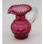 A Victorian cranberry glass water jug, the wavy rim above a dimpled globular body, height 24cm