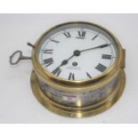 A 20th century Smiths brass cased ship's bulkhead clock, the enamel dial showing Roman numerals,