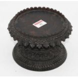 An Indian carved hardwood circular stand, dia. 17cm