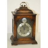 A 20th century walnut cased bracket clock, the silvered dial showing Roman numerals with pierced
