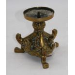 A brass pricket stick, with relief decoration, height 14.5cm