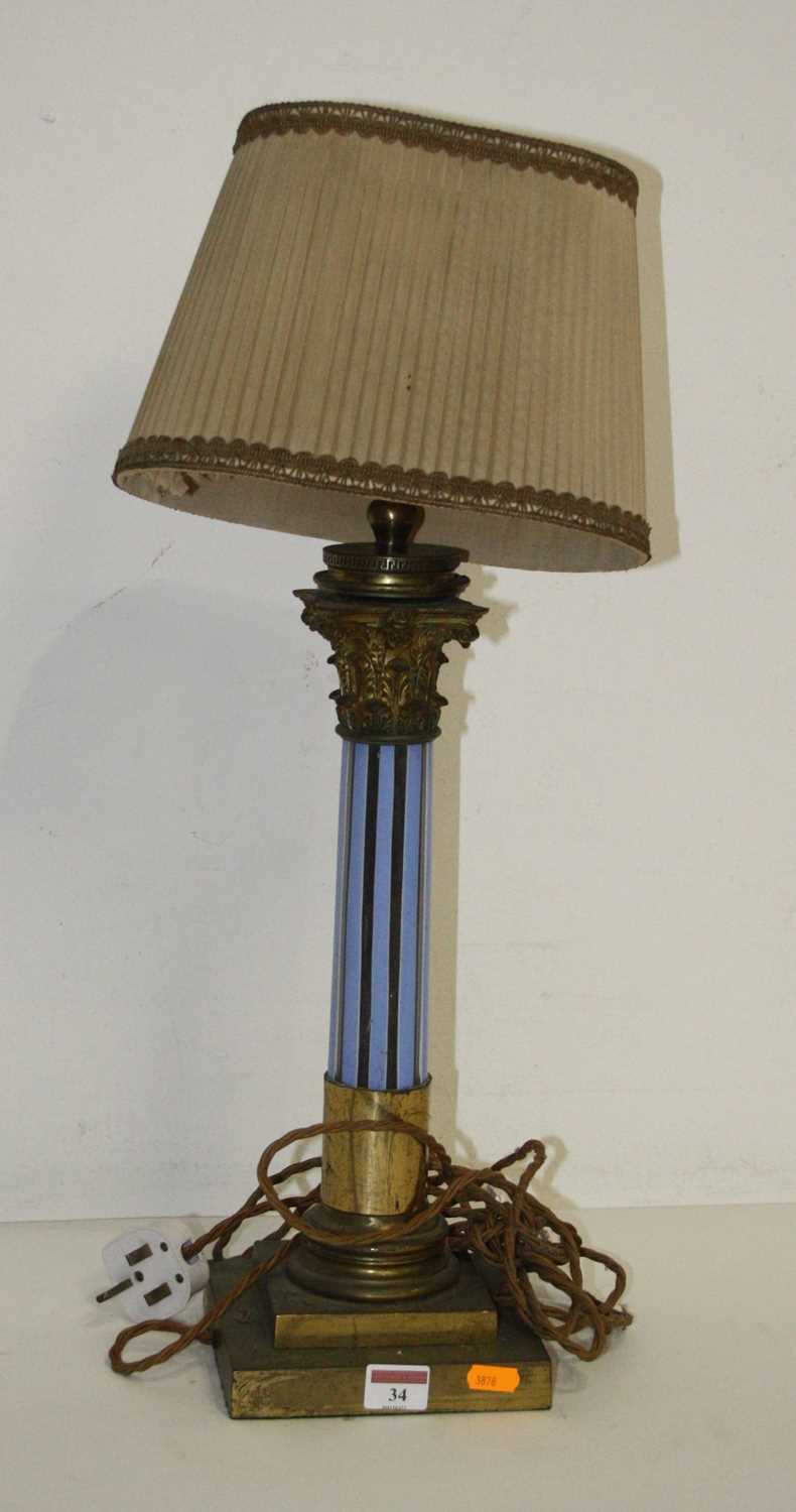 An early 20th century brass and coloured glass table lamp in the form of a Corinthian column mounted