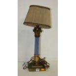 An early 20th century brass and coloured glass table lamp in the form of a Corinthian column mounted