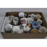 A box of various royal commemorative tea wares