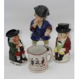 A Staffordshire style relief moulded surprise mug, height 13cm, together with three Staffordshire