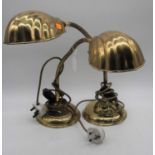 A pair of 20th century adjustable brass desk lamps, each with a scalloped shade, together with a