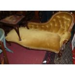 A mid-Victorian carved mahogany showframe chaise longue, having mustard dralon buttoned