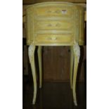 A French cream painted oval three drawer bedside chest, width 50cm